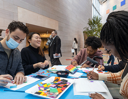 Visitors enjoying a Drop-In Art Making activity in the East Building Atrium in that National Gallery of Art.