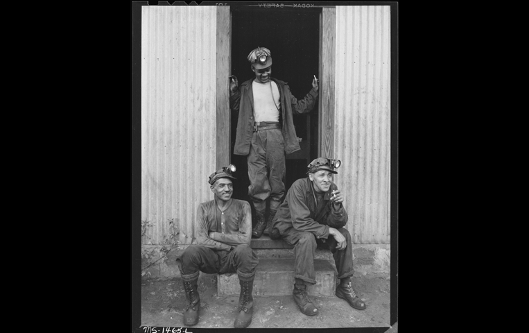 Three men in doorway of lamp house