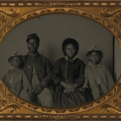 Tintype photograph of unidentified African American soldier in Union uniform with wife and two daughters